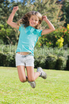 Cute girl jumping and smiling at camera