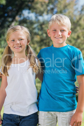 Brother and sister smiling at camera together