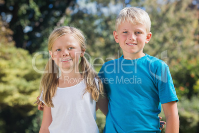 Brother and sister smiling at camera
