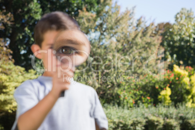 Boy holding a magnifying glass