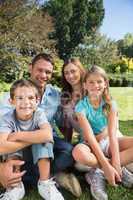 Cheerful family relaxing outside