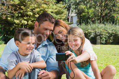 Laughing family looking at a camera