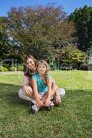 Cheerful mother and daughter on the grass