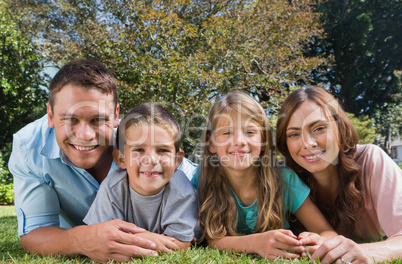 Happy family lying on the grass