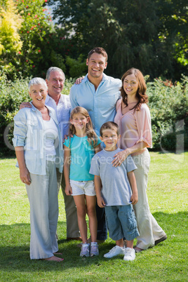 Smiling family and grandparents in the park