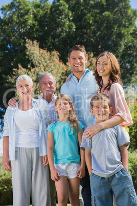 Happy family and grandparents in the countryside