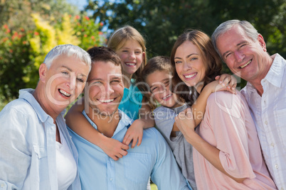 Smiling family and grandparents in the countryside embracing