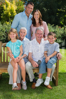 Happy multi generation family sitting in the park