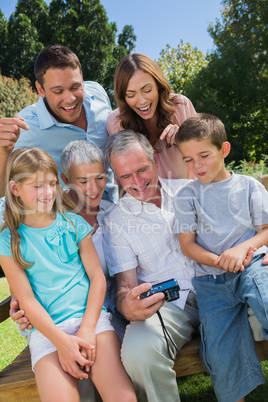 Multi generation family looking at photos