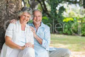 Smiling mature couple sitting together