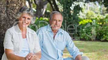 Happy mature couple smiling and looking at camera