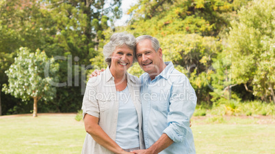 Happy mature couple smiling and looking at camera