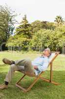 Happy man resting in sun lounger