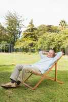Happy mature man resting in sun lounger