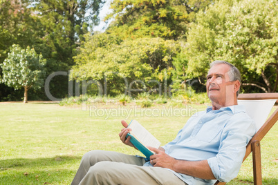 Smiling mature man holding a book