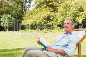 Smiling mature man holding a book