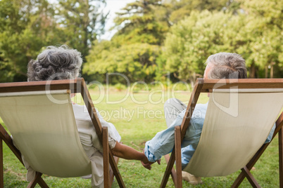 Happy mature couple holding hands