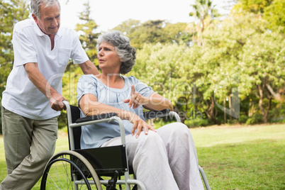 Mature woman in wheelchair speaking with partner