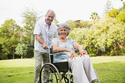 Mature woman in wheelchair with partner