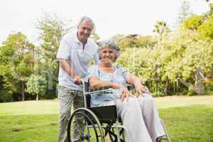 Mature woman in wheelchair with partner