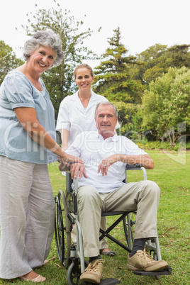 Man in wheelchair and his wife and nurse