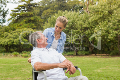Man in wheelchair and daughter talking