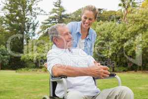 Laughing man in wheelchair and daughter talking