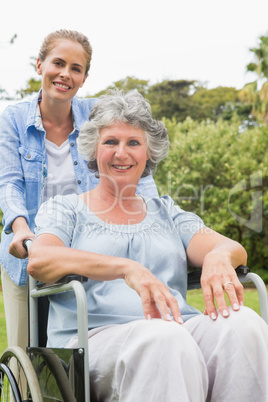 Smiling woman in wheelchair with her daughter