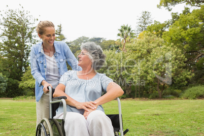 Woman in wheelchair in park with daughter