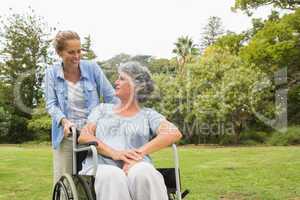 Woman in wheelchair in park with daughter