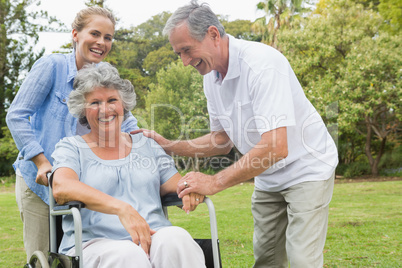 Happy woman in wheelchair with daughter and husband