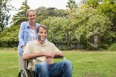 Smiling man in wheelchair with partner