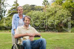 Smiling man in wheelchair with partner