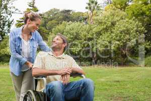 Smiling man in wheelchair talking with partner