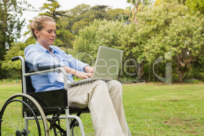 Young woman in a wheelchair with a laptop