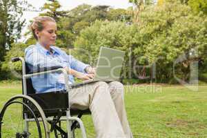 Young woman in a wheelchair with a laptop