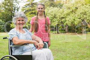 Cute granddaughter with grandmother in her wheelchair