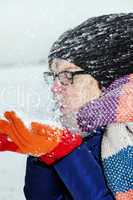 Woman holding snow in their hands