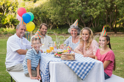 Family smiling at camera at birthday party