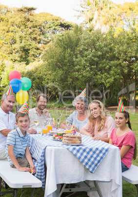 Happy family smiling at camera at birthday party
