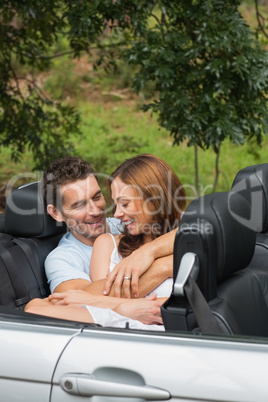 Cute couple cuddling in the backseat and chatting