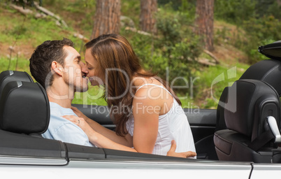 Young couple smooching on the backseat
