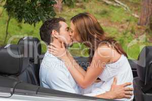 Beautiful couple kissing in back seat