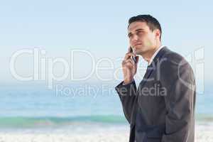 Pensive businessman on the phone