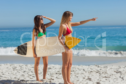 Two gorgeous women going to surf