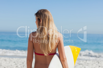 Gorgeous blond woman going to surf