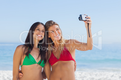 Two attractive friends taking pictures