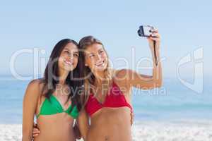 Two attractive friends taking pictures