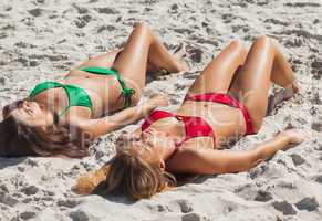 Relaxed sexy brunette and blonde taking sun