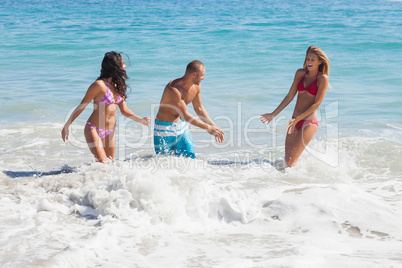 Cheerful friends playing in the sea